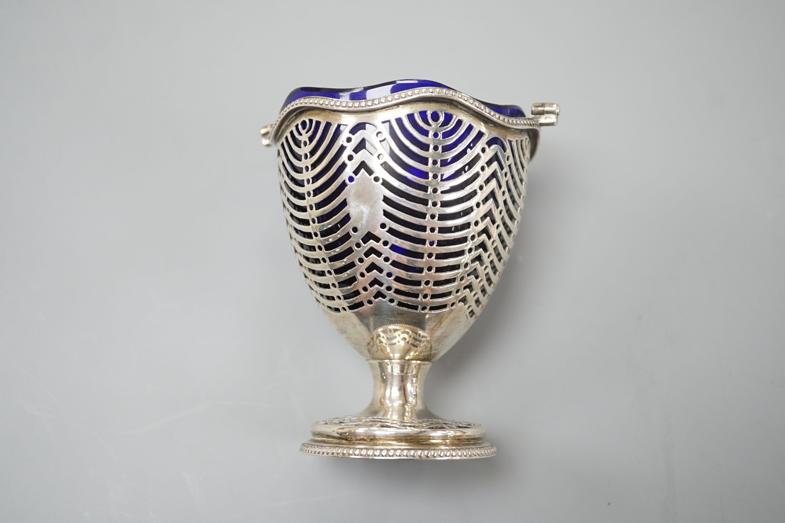 A George III pierced silver sugar basket, Burrage Davenport, London, 1777, with blue glass liner, height 96mm.